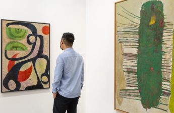 A man viewing a painting at Art Basel Hong Kong