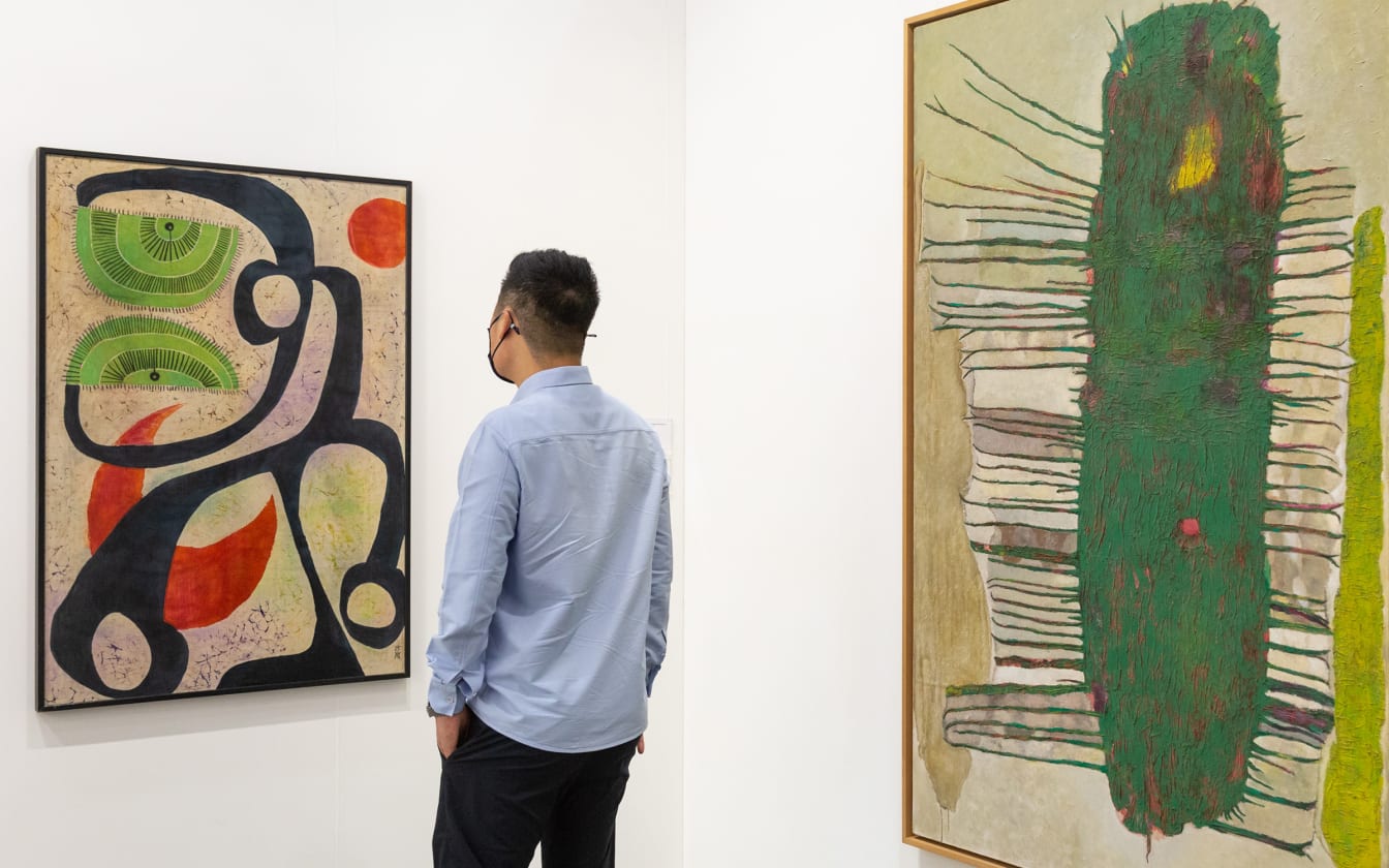 A man viewing a painting at Art Basel Hong Kong