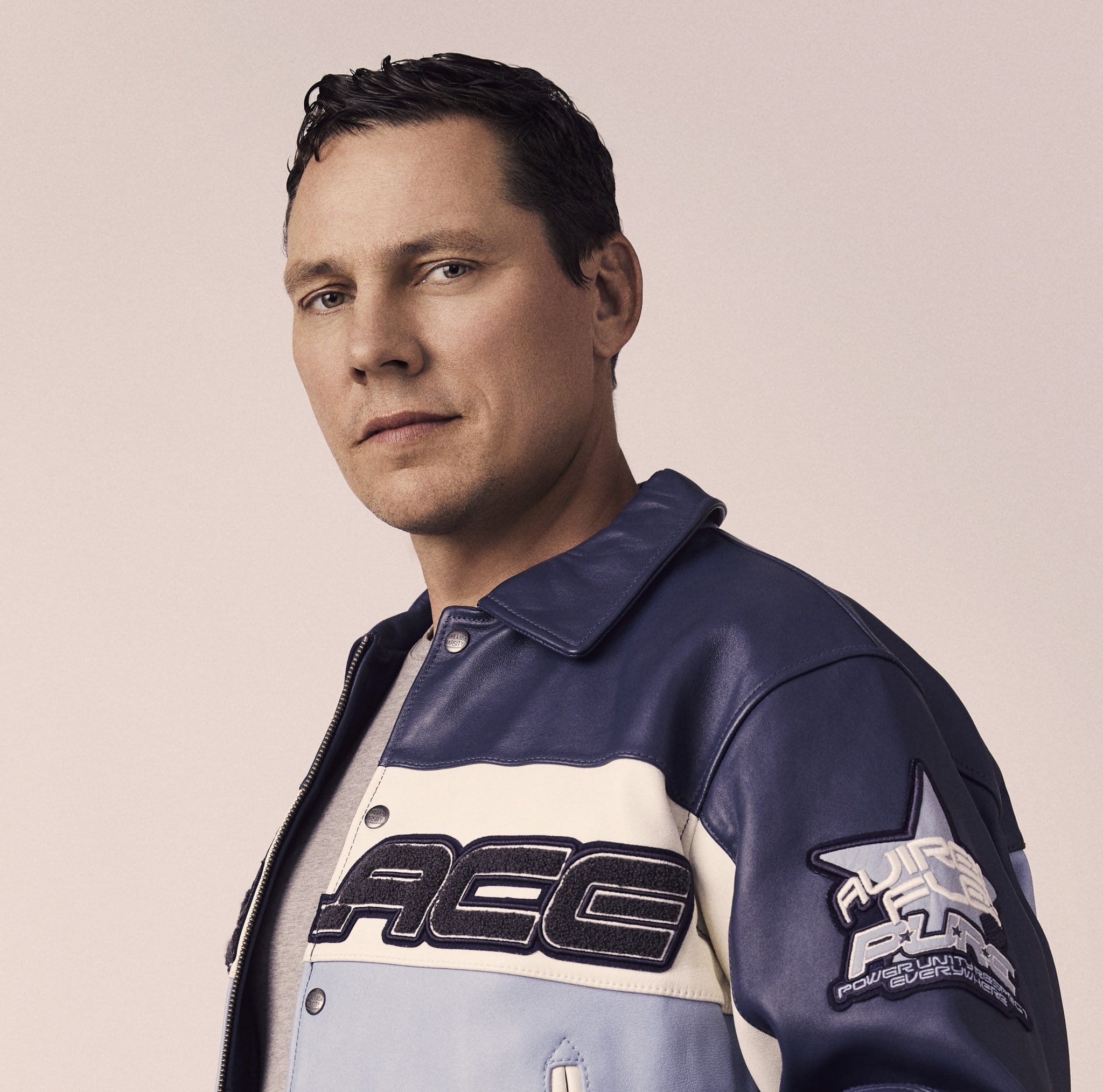 DJ and producer Tiësto in a blue and white jacket