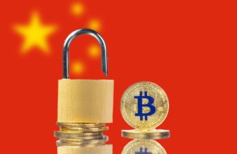 An image of a physical Bitcoin and padlock in front of the flag of China, where Crypto is highly regulated or banned