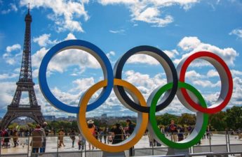 image of the Olympics logo alongside the Eiffel Tower in Paris for the 2024 event