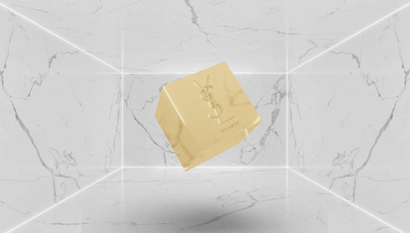 The picture shows a gold cube with YSL engraving suggesting Yves Saint Laurent Beauté's entry to the NFT space.